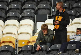HULL, ENGLAND - MAY 09:  Hull City fans look on, after their loss to Stoke City during the Barclays Premier League match between Hull City and Stoke City at the KC Stadium on May 9, 2009 in Hull, England.  (Photo by Matthew Lewis/Getty Images)