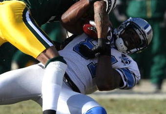 GREEN BAY, WI - DECEMBER 28:  Al Harris #31 of the Green Bay Packers brings down Calvin Johnson #81 of the Detroit Lions on December 28, 2008 at Lambeau Field in Green Bay, Wisconsin. The Packers defeated the Lions 31-21. (Photo by Jonathan Daniel/Getty Images)