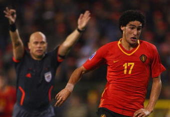BRUSSELS, BELGIUM - OCTOBER 15:  FIFA referee Tom Henning Ovrebo from Norway plays advantage with Marouane Fellaini of Belgium in possession during the FIFA 2010 World Cup Group 5 Qualifier between Belgium and Spain at the King Baudouin Stadium on October 15, 2008 in Brussels, Belgium.  (Photo by Mike Hewitt/Getty Images)