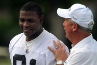 CHARLOTTE,NC- MAY 1: First round draft pick Everette Brown #91 of the Carolina Panthers smiles as Head Coach John Fox (R) pats him on the back as they walk off the field the minicamp practice at the team's practice facility on May 1, 2009 in Charlotte, North Carolina. (Photo by Steve Dykes/Getty Images)