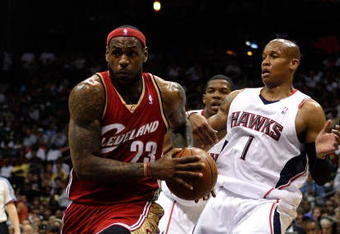 ATLANTA - MAY 09:  LeBron James #23 of the Cleveland Cavaliers drives between Joe Johnson #2 and Maurice Evans #1 of the Atlanta Hawks in Game Three of the Eastern Conference Semifinals during the 2009 NBA Playoffs at Philips Arena on May 9, 2009 in Atlanta, Georgia.  NOTE TO USER: User expressly acknowledges and agrees that, by downloading and/or using this Photograph, user is consenting to the terms and conditions of the Getty Images License Agreement.  (Photo by Andy Lyons/Getty Images)