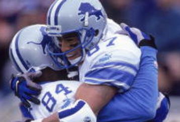 24 Sep 2000:  Johnnie Morton #87 of the Detroit Lions hugs teammate Herman Moore #84 (R-L) in celebration during the game against the Chicago Bears at Soldier Field in Chicago, Illinois.  The Lions defeated the Bears 21-14.Mandatory Credit: Jonathan Daniel  /Allsport