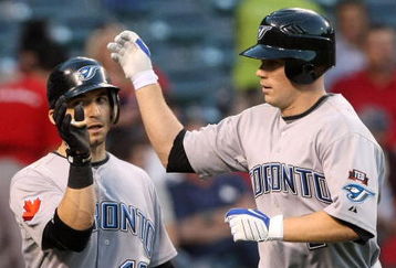 ANAHEIM, CA - MAY 6:  Aaron Hill #2 of the Toronto Blue Jays is greeted at home plate by Marco Scutaro #19 after both scored on Hill's first inning home run against the Los Angeles Angels of Anaheim at Angel Stadium May 6, 2009 in Anaheim, California.  (Photo by Stephen Dunn/Getty Images)