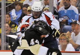 PITTSBURGH - MAY 08:  Brooks Orpik #44 of the Pittsburgh Penguins collides with Alex Ovechkin #8 of the Washington Capitals while chasing down a loose puck during Game Four of the Eastern Conference Semifinal Round of the 2009 Stanley Cup Playoffs at Mellon Arena on May 8, 2009 in Pittsburgh, Pennsylvania.  (Photo by Jamie Sabau/Getty Images)
