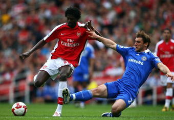 LONDON - MAY 10:  Emmanuel Adebayor of Arsenal is tackled by Branislav Ivanovic of Chelsea during the Barclays Premier League match between Arsenal and Chelsea at the Emirates Stadium on May 10, 2009 in London, England.  (Photo by Jamie McDonald/Getty Images)