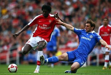 LONDON - MAY 10:  Emmanuel Adebayor of Arsenal is tackled by Branislav Ivanovic of Chelsea during the Barclays Premier League match between Arsenal and Chelsea at the Emirates Stadium on May 10, 2009 in London, England.  (Photo by Jamie McDonald/Getty Images)