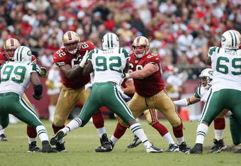 SAN FRANCISCO - DECEMBER 07:  Chilio Rachal #62 and Eric Heitmann #6 of the San Francisco 49ers blocks Shaun Ellis #92 of the New York Jets during an NFL game on December 7, 2008 at Candlestick Park in San Francisco, California. (Photo by Jed Jacobsohn/Getty Images)