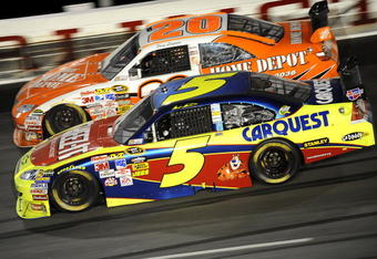 DARLINGTON, SC - MAY 09: Mark Martin, driver of the #5 Cheez-it/CarQuest Chevrolet, races with Joey Logano, driver of the #20 The Home Depot Toyota, during the NASCAR Sprint Cup Series Southern 500 on May 9, 2009 at Darlington Raceway in Darlington, South Carolina.  (Photo by John Harrelson/Getty Images)