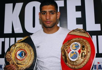 LONDON, ENGLAND - APRIL 22:  Amir Khan  poses with his belts at the press conference prior to his forthcoming WBA Light-welterweight fight against Andreas Kotelnik of the Ukraine at O2 Arena on April 22, 2009 in London, England.  (Photo by John Gichigi/Getty Images)