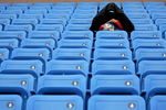 NEW YORK - SEPTEMBER 02:  A lone tennis fan waits for play during a rain delay at the U.S. Open at the USTA Billie Jean King National Tennis Center in Flushing Meadows Corona Park on September 2, 2006 in the Flushing neighborhood of the Queens borough of New York City.  (Photo by Jamie Squire/Getty Images)