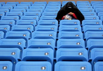 NEW YORK - SEPTEMBER 02:  A lone tennis fan waits for play during a rain delay at the U.S. Open at the USTA Billie Jean King National Tennis Center in Flushing Meadows Corona Park on September 2, 2006 in the Flushing neighborhood of the Queens borough of New York City.  (Photo by Jamie Squire/Getty Images)