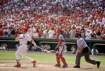 27 Sep 1998:  Mark McGwire #25 of the St. Louis Cardinals hits his 70th home run of the season as catcher Michael Barrett #5 of the Montreal Expos and umpire Rich Rieker watch during a game at the Busch Stadium in St. Louis, Missouri. The Cardinals defeat