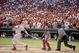 27 Sep 1998:  Mark McGwire #25 of the St. Louis Cardinals hits his 70th home run of the season as catcher Michael Barrett #5 of the Montreal Expos and umpire Rich Rieker watch during a game at the Busch Stadium in St. Louis, Missouri. The Cardinals defeat
