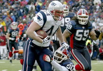 ORCHARD PARK, NY - DECEMBER 28: Heath Evans #44 of the New England Patriots runs after a catch for 12 yards as Ko Simpson #30 of the Buffalo Bills  makes the tackle at Ralph Wilson Stadium on December 28, 2008 in Orchard Park, New York. The Patriots won 13-0.  (Photo by Rick Stewart/Getty Images)
