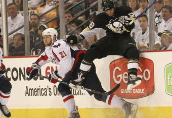 PITTSBURGH - MAY 11: Brooks Laich #21 of the Washington Capitals sidesteps a hit by Kris Letang #58 of the Pittsburgh Penguins during Game Six of the Eastern Conference Semifinal Round of the 2009 Stanley Cup Playoffs at Mellon Arena on May 11, 2009 in Pittsburgh, Pennsylvania. The Capitals defeated the Penguins 5-4 in overtime.  Photo by Bruce Bennett/Getty Images)