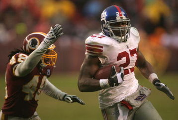 LANDOVER, MD - NOVEMBER 30:  Brandon Jacobs #27 of the New York Giants runs with the ball against Chris Horton #48 of the Washington Redskins during their game at FedEx Field on November 30, 2008 in Landover, Maryland.  (Photo by Streeter Lecka/Getty Images)