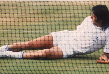 Romanian tennis player Ilie Nastase lying on the court during a match at the Wimbledon Tennis Championships, London, 1977. (Photo by Tony Duffy/Getty Images)