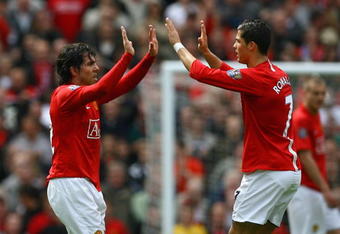 MANCHESTER, ENGLAND - MAY 10:  Cristiano Ronaldo of Manchester United congratulates team mate Carlos Tevez after he scored his team's second goal during the Barclays Premier League match between Manchester United and Manchester City at Old Trafford on May 10, 2009 in Manchester, England.  (Photo by Alex Livesey/Getty Images)