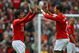 MANCHESTER, ENGLAND - MAY 10: Cristiano Ronaldo of Manchester United congratulates team mate Carlos Tevez after he scored his team's second goal during the Barclays Premier League match between Manchester United and Manchester City at Old Trafford on May 10, 2009 in Manchester, England. (Photo by Alex Livesey/Getty Images)