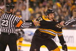 BOSTON - MAY 10: Milan Lucic #17 of the Boston Bruins has to be held back against Carolina Hurricanes the during Game Five of the Eastern Conference Semifinal Round of the 2009 Stanley Cup Playoffs on May 10, 2009 at the TD Banknorth Garden in Boston, Massachusetts. The Bruins won 4-0. (Photo by Jim Rogash/Getty Images)