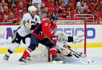 WASHINGTON - MAY 09:  Boyd Gordon #15 of the Washington Capitals tries to stuff a shot on goal between Brooks Orpik #44 and Marc-Andre Fleury #29 of the Pittsburgh Penguins during Game Five of the Eastern Conference Semifinal Round of the 2009 Stanley Cup Playoffs on May 9, 2009 at the Verizon Center in Washington,  DC.  (Photo by Len Redkoles/Getty Images)