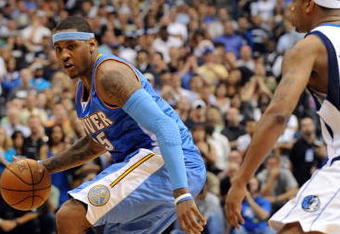 DALLAS - MAY 09:  Forward Carmelo Anthony #15 of the Denver Nuggets dribbles the ball past Antoine Wright #21 of the Dallas Mavericks during the final seconds in Game Three of the Western Conference Semifinals during the 2009 NBA Playoffs at American Airlines Center on May 9, 2009 in Dallas, Texas. NOTE TO USER: User expressly acknowledges and agrees that, by downloading and or using this photograph, User is consenting to the terms and conditions of the Getty Images License Agreement.  (Photo by Ronald Martinez/Getty Images)