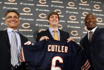 LAKE FOREST, IL - APRIL 3:  Chicago Bears general manager Jerry Angelo, quarterback Jay Cutler and head coach Lovie Smith are all smiles after introducing Cutler as their new quarterback during a press conference on April 3, 2009 at Halas Hall in Lake Forest, Illinois. (Photo by Jim Prisching/Getty Images)