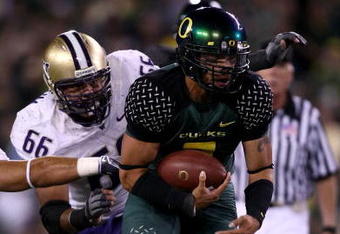 EUGENE, OR - AUGUST 30:  Quarterback Jeremiah Masoli #2 of the Oregon Ducks is chased by Daniel Te'o-Nesheim #66 of the Washington Huskies during the game at Autzen Stadium on August 30, 2008 in Eugene, Oregon.  (Photo by Jonathan Ferrey/Getty Images)
