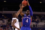 INDIANAPOLIS - MARCH 27: Sherron Collins #4 of the Kansas Jayhawks attempts a shot against Travis Walton the Michigan State Spartans during the third round of the NCAA Division I Men's Basketball Tournament at the Lucas Oil Stadium on March 27, 2009 in Indianapolis, Indiana. (Photo by Andy Lyons/Getty Images)