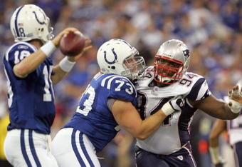 INDIANAPOLIS - JANUARY 21:  Peyton Manning #18 of the Indianapolis Colts prepares to throw a touch down pass as Ty Warren #94 of the New England Patriots gets blocked by Jake Scott #73 during the AFC Championship Game on January 21, 2007 at the RCA Dome in Indianapolis, Indiana.  The Colts won the game 38-34.  (Photo by Doug Pensinger/Getty Images)
