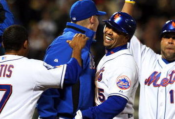 NEW YORK - MAY 12:  Carlos Beltran #15 of the New York Mets celebrates with his teammates after his bases loaded base on ball in the tenth inning against the Atlanta Braves at Citi Field May 12, 2009 in the Flushing neighborhood of the Queens borough of New York City. The Mets defeated the Braves 4-3 in ten innings.  (Photo by Jim McIsaac/Getty Images)