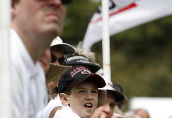 UNITED STATES - APRIL 12:  A young South Carolina Gamecocks fan looks on as head football coach Steve Spurrier tees off during the Verizon Heritage Pro-Am Wednesday, April 12, 2006, at Harbour Town Golf Links in Hilton Head Island, South Carolina.  (Photo by Kevin C. Cox/Getty Images)