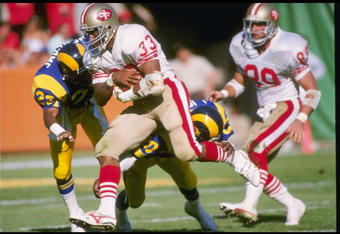 16 Oct 1988: Running back Roger Craig of the San Francisco 49ers tries to break tackles during a game against the Los Angeles Rams at Anaheim Stadium in Anaheim, California. The 49ers won the game 24-21.