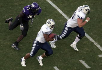 FORT WORTH, TX - SEPTEMBER 28:  Running back Manase Tonga #11 of the Brigham Young University Cougars runs for a touchdown past Robert Henson #51 of the Texas Christian University Horned Frogs at Amon G. Carter Stadium on September 28, 2006 in Fort Worth, Texas.  (Photo by Ronald Martinez/Getty Images)