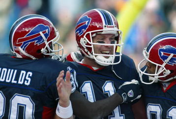 ORCHARD PARK, NY - DECEMBER 29:  Drew Bledsoe #11 of the Buffalo Bills celebates scoring a touchdown with teammates Eric Moulds #80 and Peerless Price #81 against the Cincinnati Bengals at Ralph Wilson Stadium on December 29, 2002 in Orchard Park, New York. The Bills defeated the Bengals 27-9. (Photo by Rick Stewart/Getty Images)