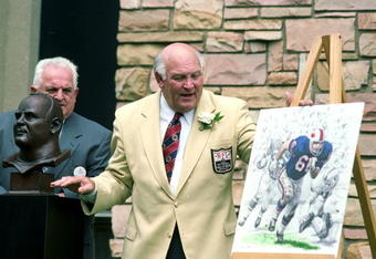 7 Aug 1999: Billy Shaw talks to the press as he looks at a picture of himself during his induction into the Pro Football Hall of Fame in Canton, Ohio.