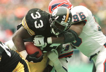 6 JAN 1996:  RUNNING BACK BYRON 'BAM' MORRIS #33 OF THE PITTSBURGH STEELERS POWERS INTO THE ENDZONE FOR A TOUCHDOWN DESPITE THE ATTEMPTED TACKLE BY LINEBACKER MONTY BROWN #96 OF THE BUFFALO BILLS DURING THE FOURTH QUARTER OF THE STEELERS'' 40-21 AFC PLAYOF