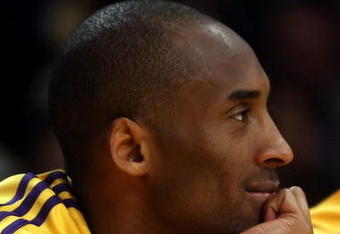 LOS ANGELES, CA - MAY 12:  Kobe Bryant #24 of the Los Angeles Lakers smiles on the bench late in the fourth quarter against the Houston Rockets in Game Five of the Western Conference Semifinals during the 2009 NBA Playoffs at Staples Center on May 12, 2009 in Los Angeles, California. NOTE TO USER: User expressly acknowledges and agrees that, by downloading and or using this photograph, User is consenting to the terms and conditions of the Getty Images License Agreement.  (Photo by Stephen Dunn/Getty Images)