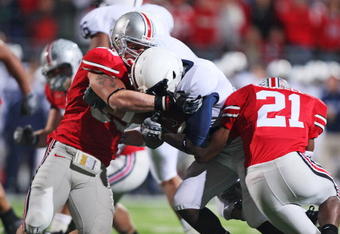 COLUMBUS, OH - OCTOBER 25: James Laurinaitis #33 and Anderson Russell #21 of the Ohio State Buckeyes stop running back Stephfon Green #21 of the Penn State Nittany Lions on October 25, 2008 at Ohio Stadium in Columbus, Ohio.  (Photo by Jamie Sabau/Getty Images)