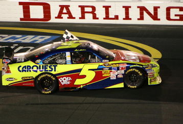DARLINGTON, SC - MAY 09:  Mark Martin, driver of the #5 Cheez-It/CARQUEST Chevrolet, waves the checkered flag while doing a victory lap after winning the NASCAR Sprint Cup Series Southern 500 on May 9, 2009 at Darlington Raceway in Darlington, South Carolina.  (Photo by Chris Trotman/Getty Images)