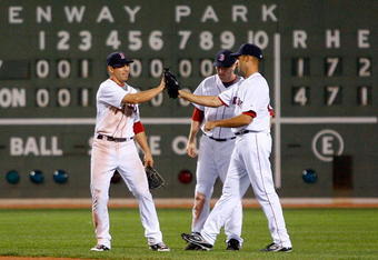 BOSTON - APRIL 26: Jacoby Ellsbury #46, J.D. Drew #7, and Jonathan Van Every of the Boston Red Sox celebrate a 4-1 win against the New York Yankees at Fenway Park April 26, 2009 in Boston, Massachusetts. (Photo by Jim Rogash/Getty Images)