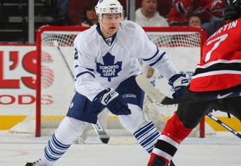 NEWARK, NJ - APRIL 07: Luke Schenn #2 of the Toronto Maple Leafs defends against the New Jersey Devils on April 7, 2009 at the Prudential Center in Newark, New Jersey. The Maple Leafs defeated the Devils 4-1. (Photo by Bruce Bennett/Getty Images)