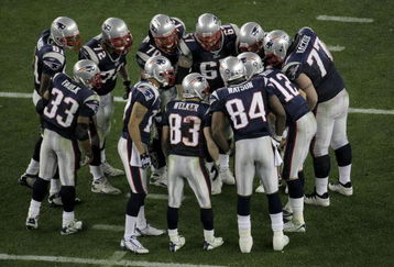 GLENDALE, AZ - FEBRUARY 03:  The New England Patriots huddle as they listen for a play by quarterback Tom Brady #12 of the New England Patriots in Super Bowl XLII against the New York Giants on February 3, 2008 at the University of Phoenix Stadium in Glendale, Arizona. The Giants defeated the Patriots 17-14. (Photo by Doug Pensinger/Getty Images)