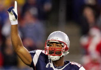 FOXBORO, MA - DECEMBER 23:  Kelley Washington #15 of the New England Patriots tries to fire up the crowd at the start of the game against the Miami Dolphins at Gillette Stadium on December 23, 2007 in Foxboro, Massachusetts.  (Photo by Jim McIsaac/Getty Images)