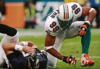 MIAMI - DECEMBER 16:  Defensive end Jason Taylor #99 of the Miami Dolphins celebrates after sacking Kyle Boller #7 of the Baltimore Ravens at Dolphin Stadium December 16, 2007 in Miami, Florida. The Dolphins defeated the Ravens 22-16 for their first victory of the year.  (Photo by Doug Benc/Getty Images)