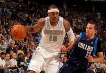 DENVER - MAY 13:  Carmelo Anthony #15 of the Denver Nuggets drives past Jose Juan Barea #11 of the Dallas Mavericks in Game Five of the Western Conference Semifinals during the 2009 NBA Playoffs at Pepsi Center on May 13, 2009 in Denver, Colorado.  The Nuggets defeated the Mavericks 124-110 to advance to the Western Conference Finals.  NOTE TO USER: User expressly acknowledges and agrees that, by downloading and or using this photograph, User is consenting to the terms and conditions of the Getty Images License Agreement.  (Photo by Doug Pensinger/Getty Images)
