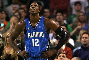 BOSTON - MAY 12:  Dwight Howard #12 of the Orlando Magic reacts after he is called for a foul in the second half against the Boston Celtics in Game Five of the Eastern Conference Semifinals during the 2009 NBA Playoffs at TD Banknorth Garden May 12, 2009 in Boston, Massachusetts. The Celtics defeated the Magic 92-88.  NOTE TO USER: User expressly acknowledges and agrees that, by downloading and or using this photograph, User is consenting to the terms and conditions of the Getty Images License Agreement.  (Photo by Elsa/Getty Images)