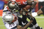 TAMPA, FL - AUGUST 17: Quarterback Josh Johnson #11 of the Tampa Bay Buccaneers is sacked by linebacker Vince Redd #49 of the New England Patriots at Raymond James Stadium on August 17, 2008 in Tampa, Florida. (Photo by Al Messerschmidt/Getty Images)