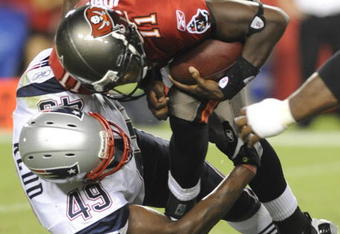 TAMPA, FL - AUGUST 17: Quarterback Josh Johnson #11 of the Tampa Bay Buccaneers is sacked by linebacker Vince Redd #49 of the New England Patriots at Raymond James Stadium on August 17, 2008 in Tampa, Florida. (Photo by Al Messerschmidt/Getty Images)