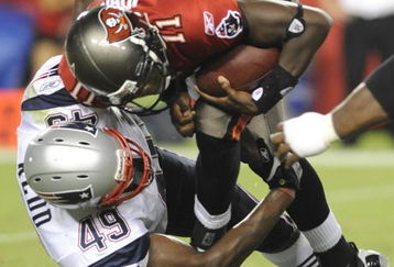 TAMPA, FL - AUGUST 17: Quarterback Josh Johnson #11 of the Tampa Bay Buccaneers is sacked by linebacker Vince Redd #49 of the New England Patriots at Raymond James Stadium on August 17, 2008 in Tampa, Florida. (Photo by Al Messerschmidt/Getty Images)
